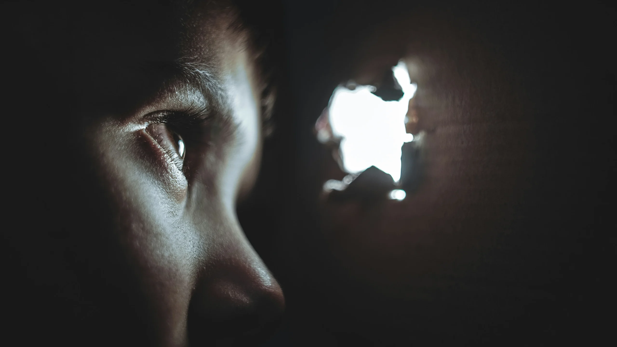 Child in the dark looking at the light